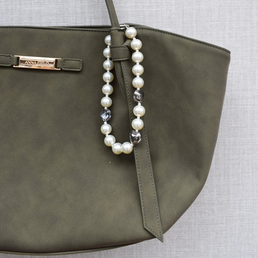 Hearts and pearls bag charm on a green bag