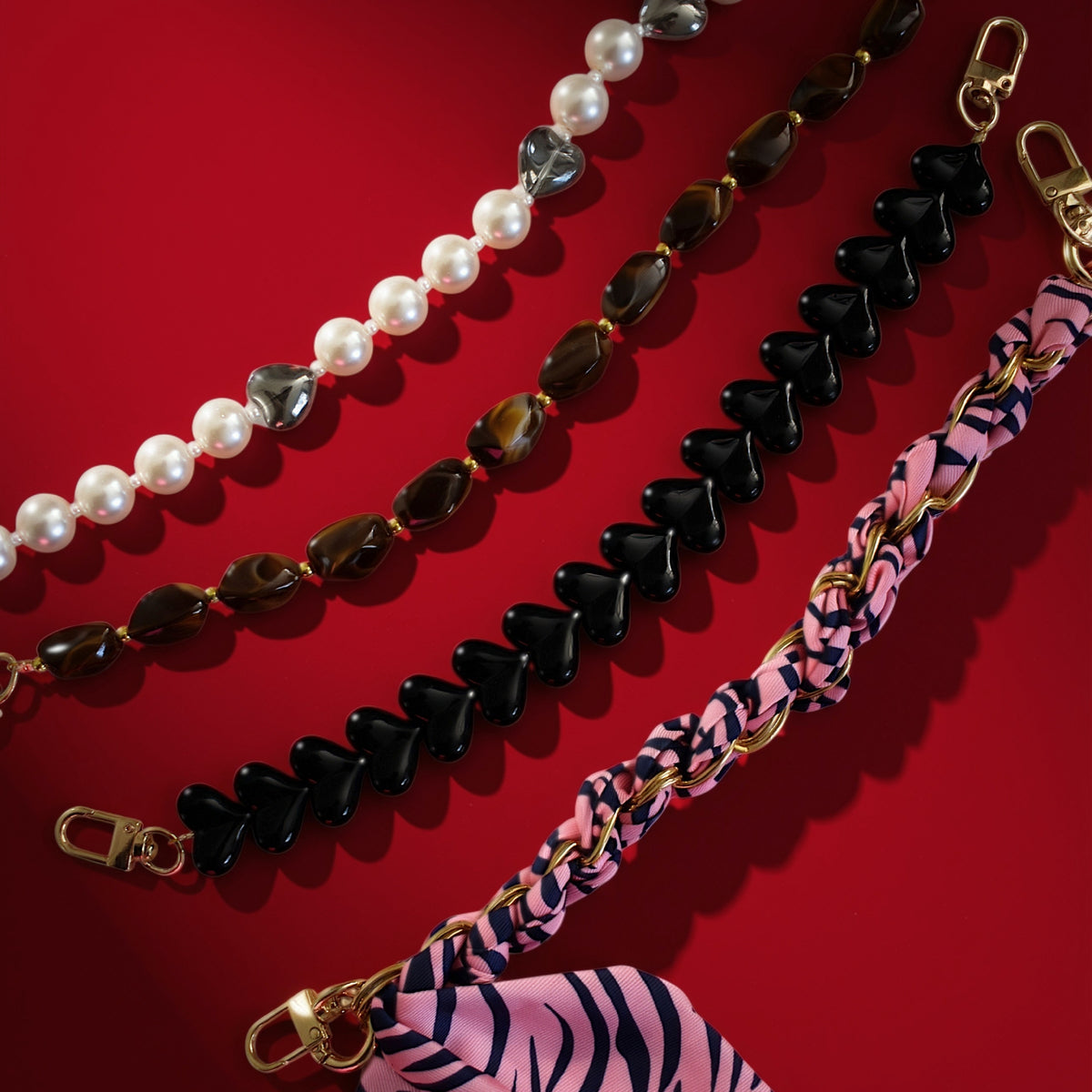 Bag charms on red background, including brown beads