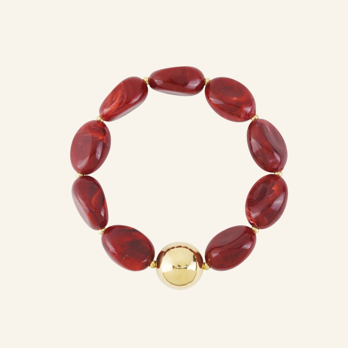 Large oval beaded bracelet with gold bead – carmine red on beige background