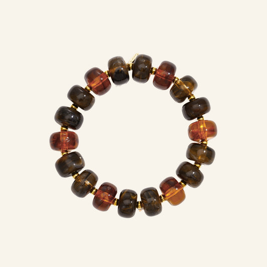 Amber kralenarmband bruin – vrijstaand op beige