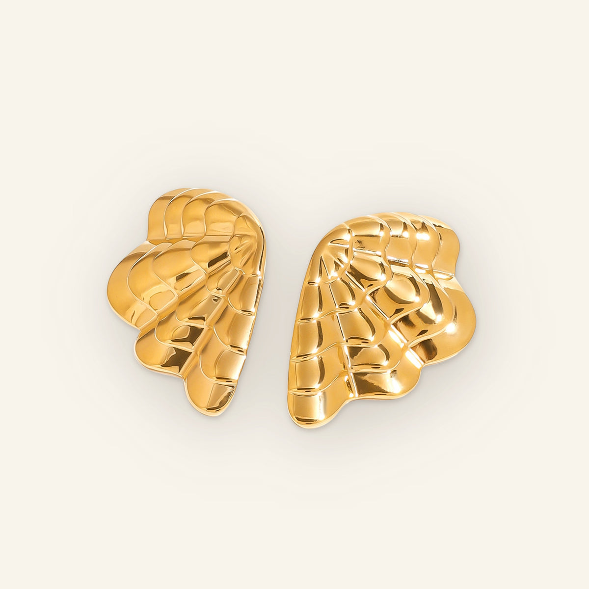 Gold shell earrings – front on beige