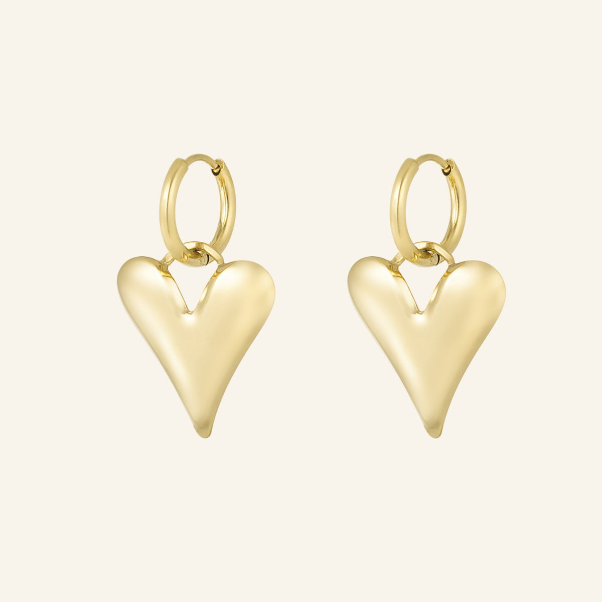 Gold heart hoop earrings – on beige background