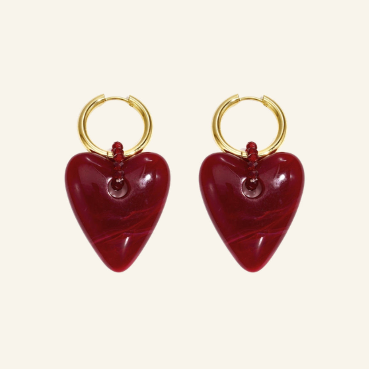 Bordeaux heart earrings – on beige background