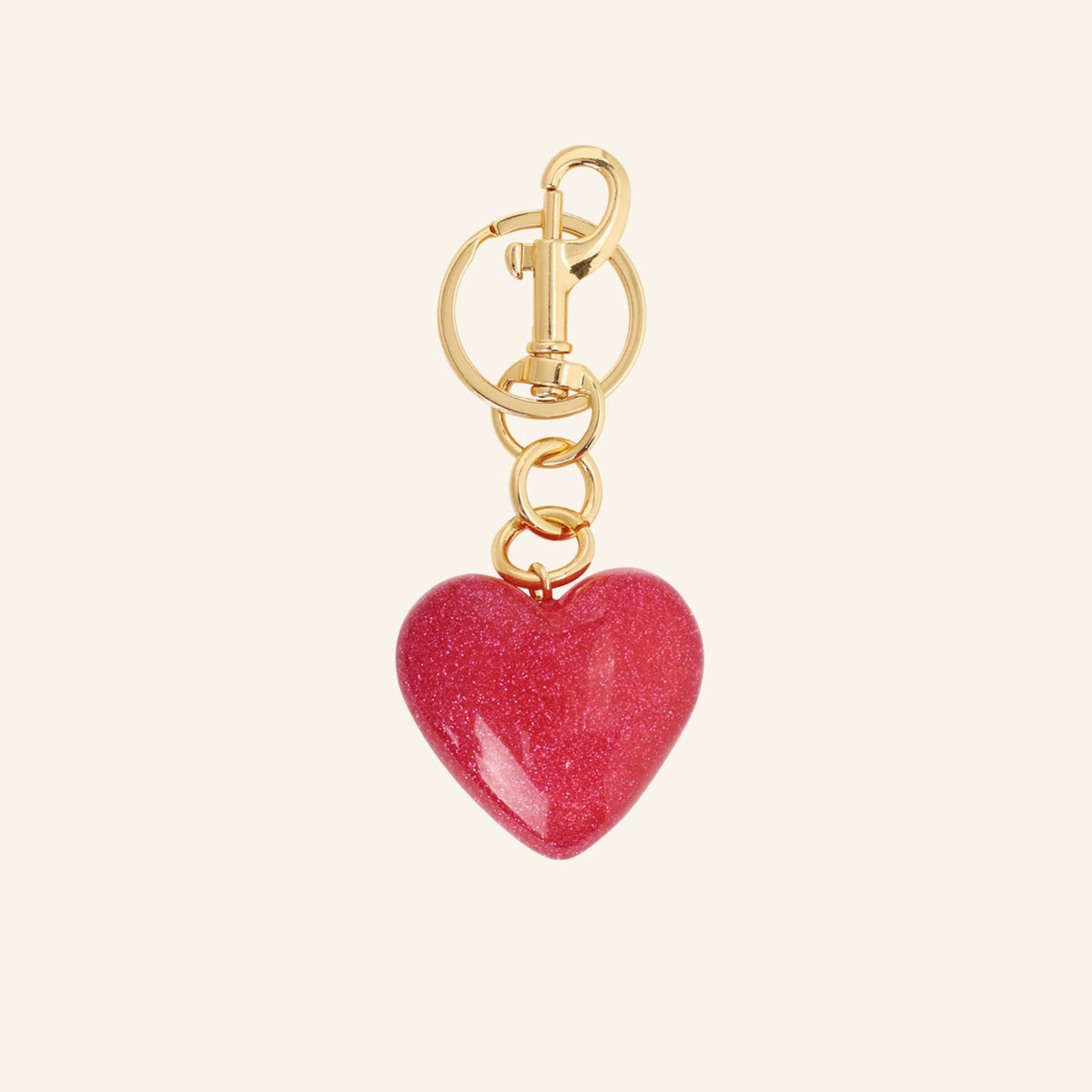 Red glitter heart bag charm – on beige background