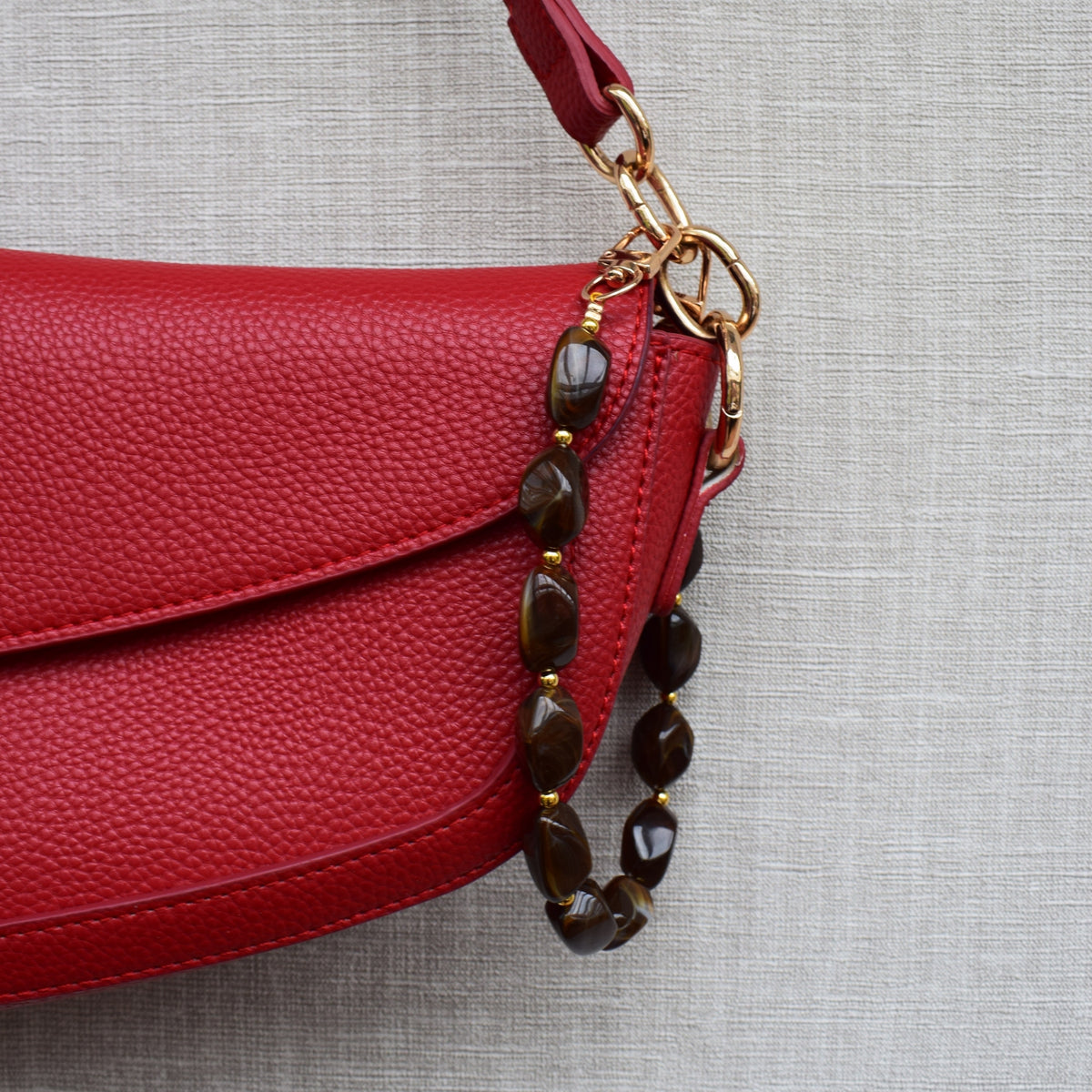 Beaded bag charm brown on a red bag