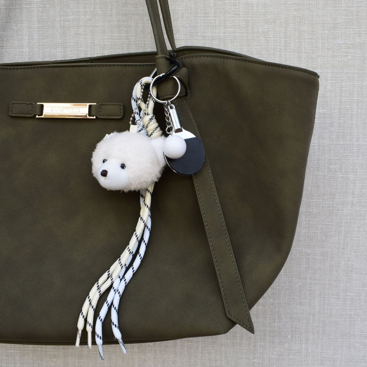 Teddy sports bag charm on a green bag