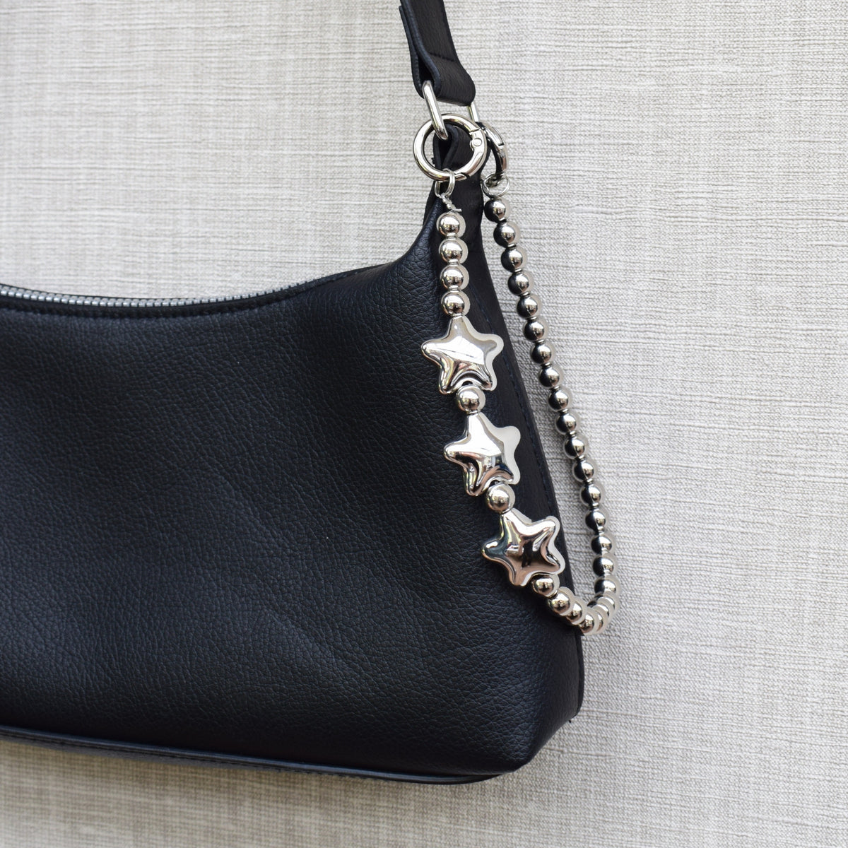 Star beads bag charm on a black bag
