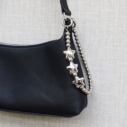 Star beads bag charm on a black bag