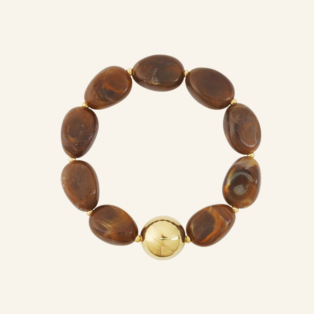 Large oval beaded bracelet with gold bead – coffee brown on beige background