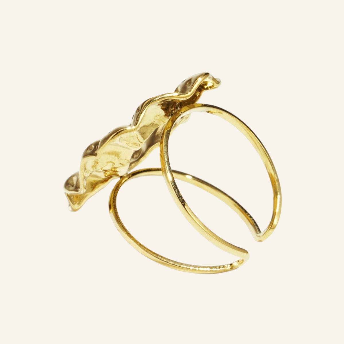 Chunky statement ring gold – side view on beige