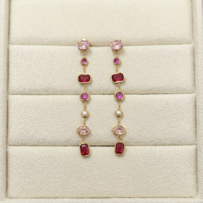Pink stone gold earrings in a jewelry box