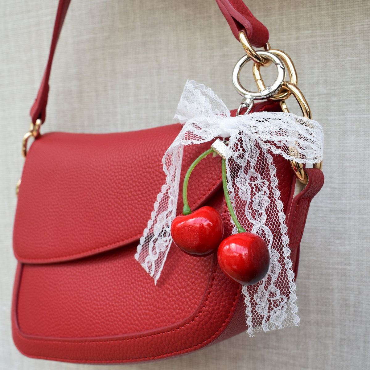 Cherry with lace bow bag charm on a red bag, another view