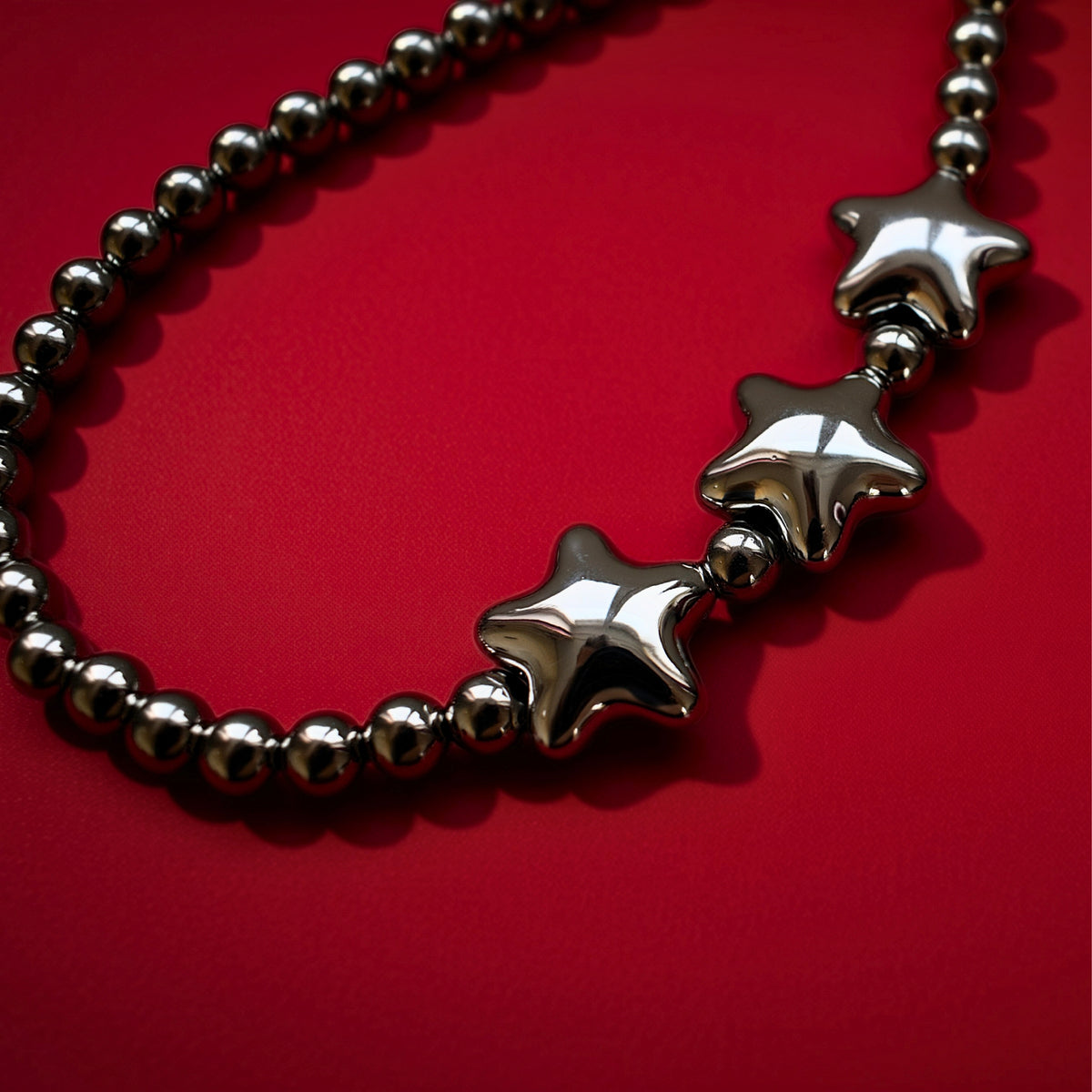 Star beads bag charm, close-up on red