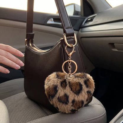 Fluffy hart bag charm met panterprint in de auto
