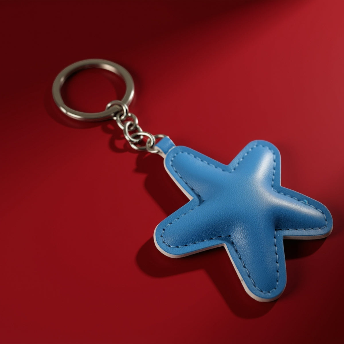 Ster van stof bag charm lichtblauw op rode achtergrond