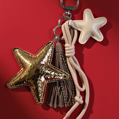 Ster bag charm met franjes goud op rood