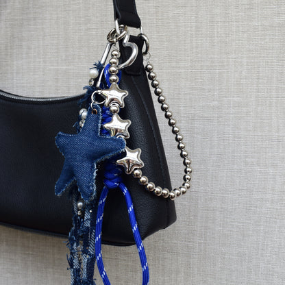 Star beads bag charm on a black bag with blue star