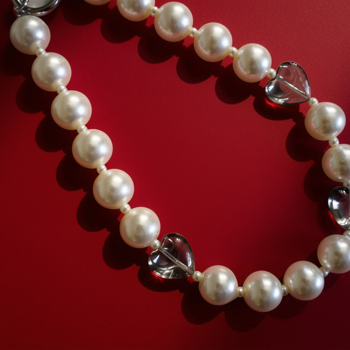 Hearts and pearls bag charm on red