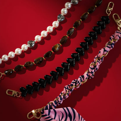 Bag charms on red background, including brown beads