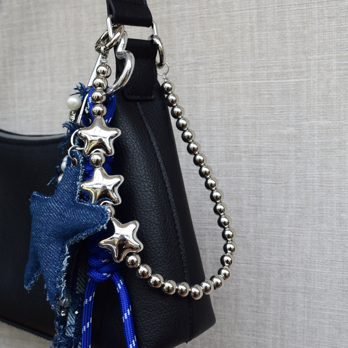 Star beads bag charm, worn on a black bag