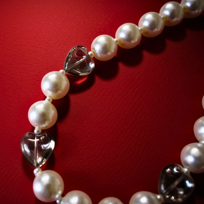 Hearts and pearls bag charm, close-up
