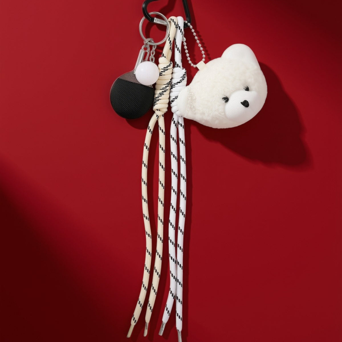 Teddy sports bag charm on red background