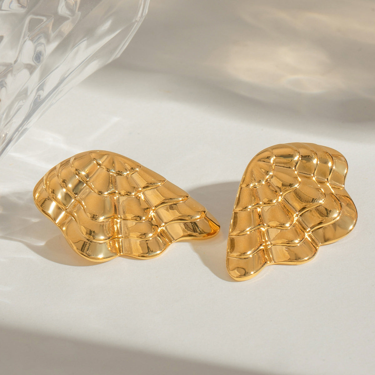 Gold shell earrings – lifestyle photo with detail