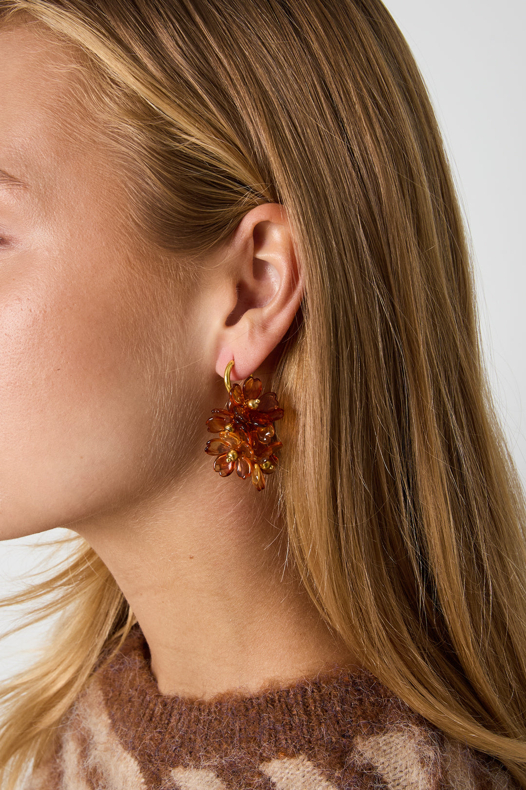 Brown flower cluster earrings, worn